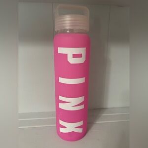 VS Pink glass water bottle with pink and white silicone logo sleeve